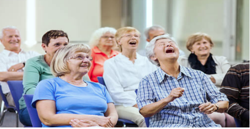 "Laughing seniors enjoying a presentation"