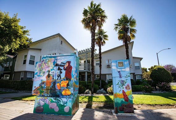 Colorful painted artwork brightens drab utility boxes.