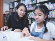 a child and tutor in a library