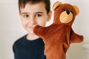 child with a hand puppet