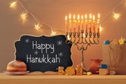 Menorah and a sign that reads happy Hanukkah 