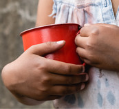Young girl holding red cup