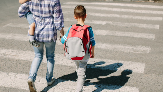 Family crossing a pedestrian crosswalk