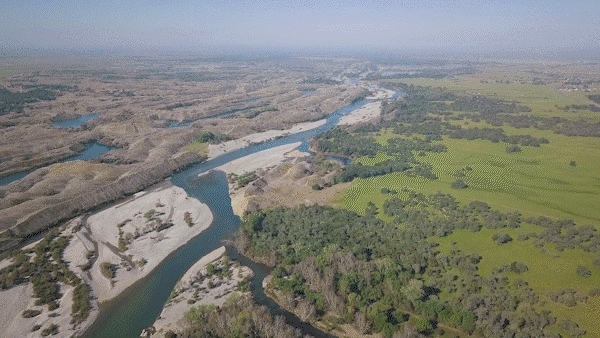 Video clips showing a river, dam, hydropower plant and rice fields. 
