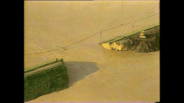 The Day the Levee Broke opening title with a levee break and murky floodwaters in the background
