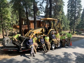 Photo of many individuals around a tractor