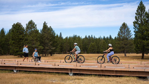 People on a raised boardwalk along a shared-use trail