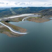 A water covered Lakeside Access Rd. is shown at Lake Oroville with the Spillway Day Use Area shown in the background.