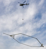 Photo of helicopter carrying large mapping magnet