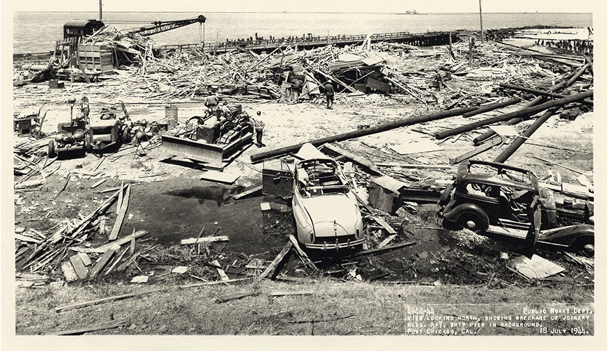 Leveled buildings and wrecked cars in the aftermath of explosion at Port Chicago munitions facility in 1944