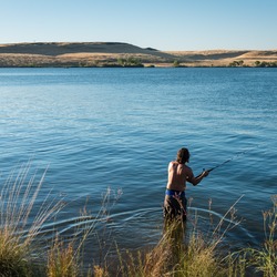 A man fishes at the Thermalito Forebay Recreation Area in Oroville. 