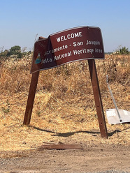 A damaged sign welcoming motorists to the Sacramento-San Joaquin Delta National Heritage Area