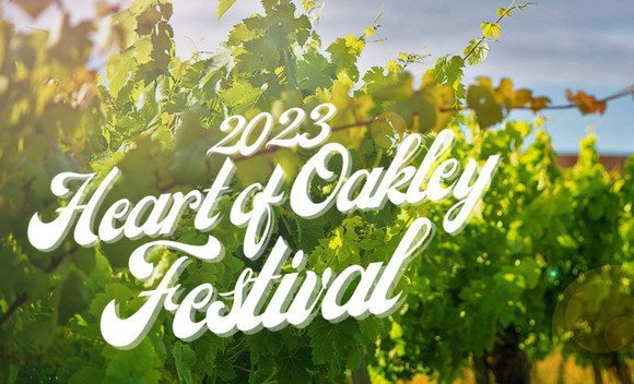 Grapevines backlit by the sun with the words "2023 Heart of Oakley Festival" superimposed