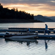 Two men prepare their boat to go fishing on Lake Oroville in the early morning hours. 