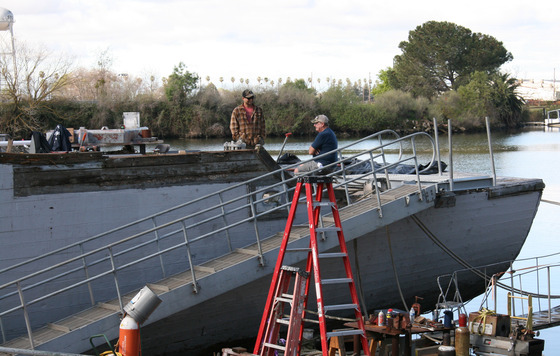 Two volunteers working on restoring the USS Lucid