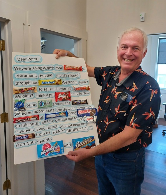 Capital District_Peter Larsen holding up candy theme sign