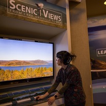 A Lake Oroville Visitor Center guide illustrates how to use a joystick to move a camera for Lake Oroville views. 