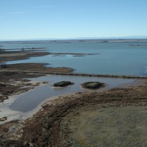 An aerial view of a brood pond area at the Thermalito Afterbay. Water surrounds two small, vegetated islands. 