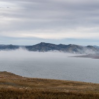 A view of fog traveling across the surface of Lake Oroville near the Oroville Dam. 