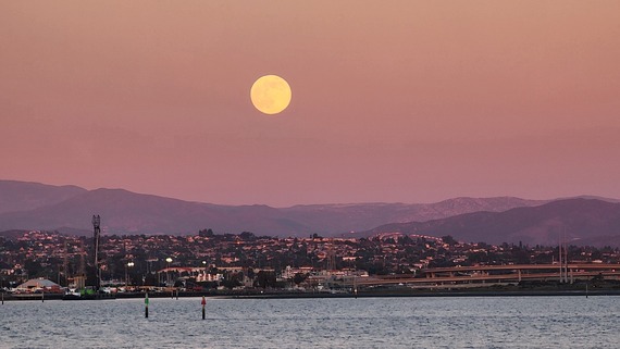 Silver Strand State Beach full moon rises above San Diego Bay.