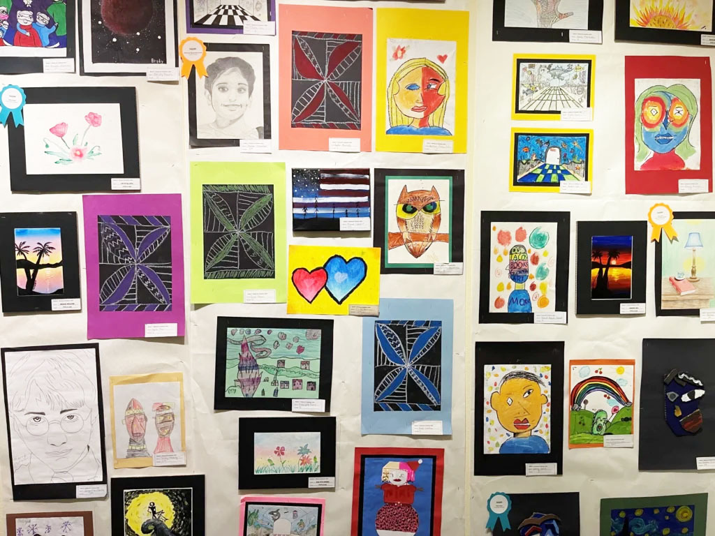 a wall of student artwork