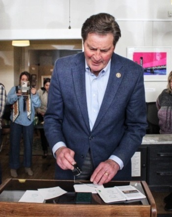 Congressman John Garamendi stamping a Passport Book