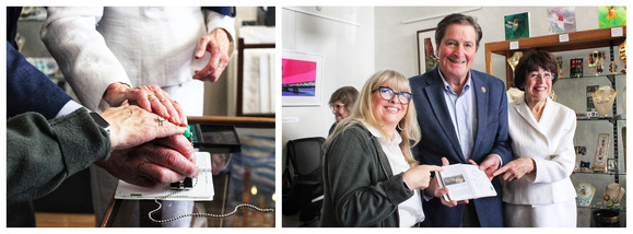 Three hands pressing down a stamp together, and two women and a man holding a passport book