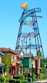 An art-emblazoned tower behind colorful houses