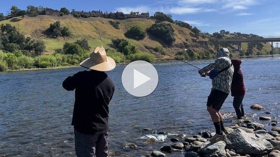 People fishing along river shore. CDFW photo