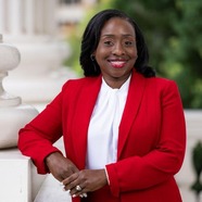 Woman in red blazer smiling at camera
