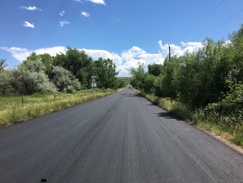 Chip sealing in progress on a county road.