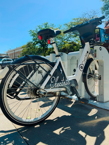 Electric Bcycle Bike parked on a charging dock in Boulder
