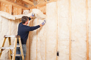 man installing insulation into walls