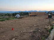 cleared lot with house being built in the background