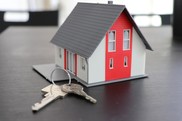 small model house on table with keys