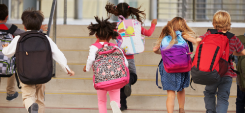Kids running with backpaks to schools 