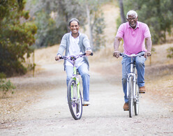 A senior African American Couple riding their bikes in nature
