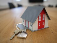 miniature house model on table with keys