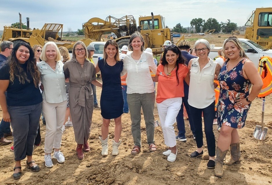 Boulder County Commissioners and housing leaders stand in front of construction equipment at Willoughby Corner groundbreaking