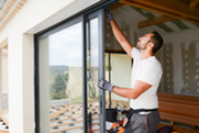 man installing a sliding glass door