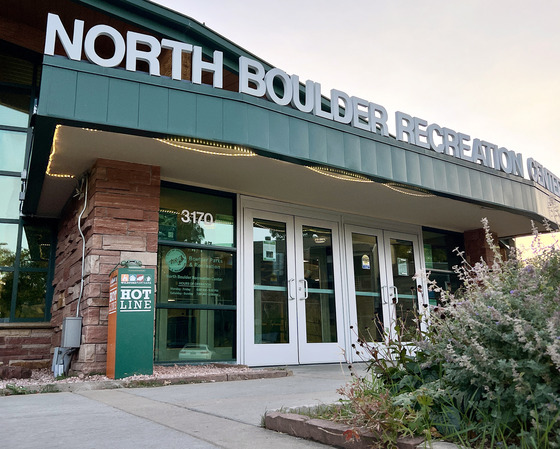 Exterior of North Boulder Recreation Center with a Wildfire Partners "HOTline" installation next to the entrance.