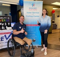 Photo of two people promoting CPWD polling location