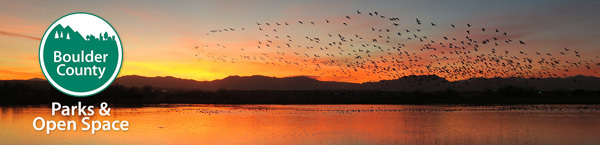Boulder County Parks & Open Space logo over a sunset
