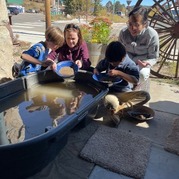 Two children pan for gold