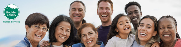 Image of a diverse group of smiling people with the Boulder County Human Services logo.