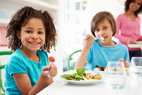 Two kids eating at a restaurant 