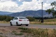 car driving by a speed tracking camera