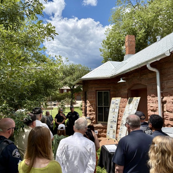 Lyons community and sheriff's office personnel at the Depot for unveiling of historical display highlighting law enforcement history in Lyons
