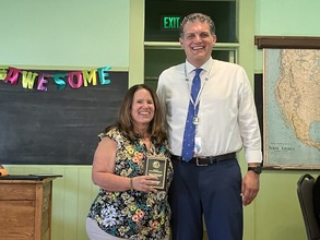 Jill, who won employee of the year, and Director Lunn pose for a picture at the employee of the year celebration