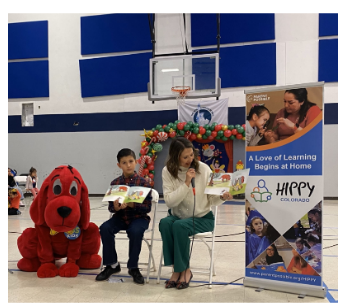 Jackie Cordova at HIPPY Program event, she is reading a book to an audience.